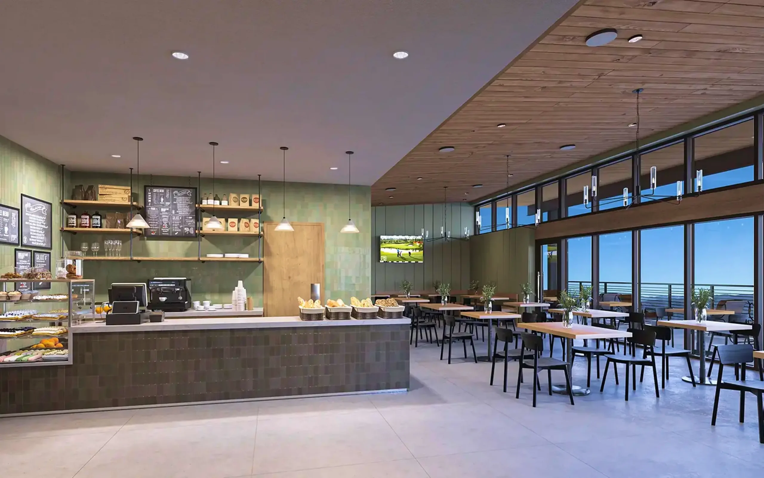 Modern café and dining area with seating and large windows overlooking the mountains