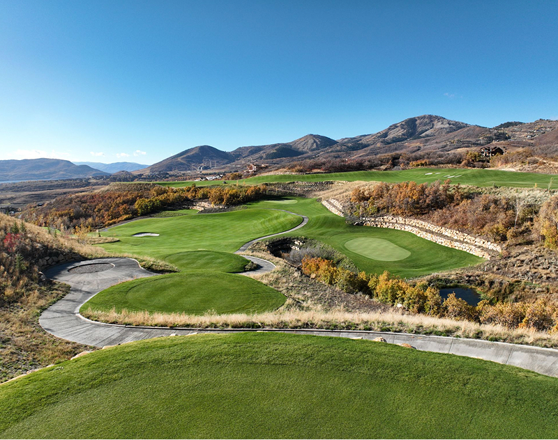 Scenic golf course holes with mountain views and winding cart paths