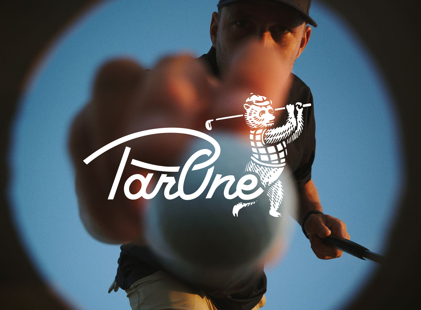 Golfer placing a golf ball on a tee with the ParOne logo overlay
